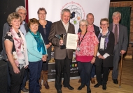 Lilian Webb, IPF AV Group Committee , Maria O'Brien, Brendan O'Sullivan, Rita Nolan, Yvonne Acheson, Margaret Finlay, Edwin Bailey & Dom Reddin, President IPF, presenting Alan Lyons with his World Cup & Citation.